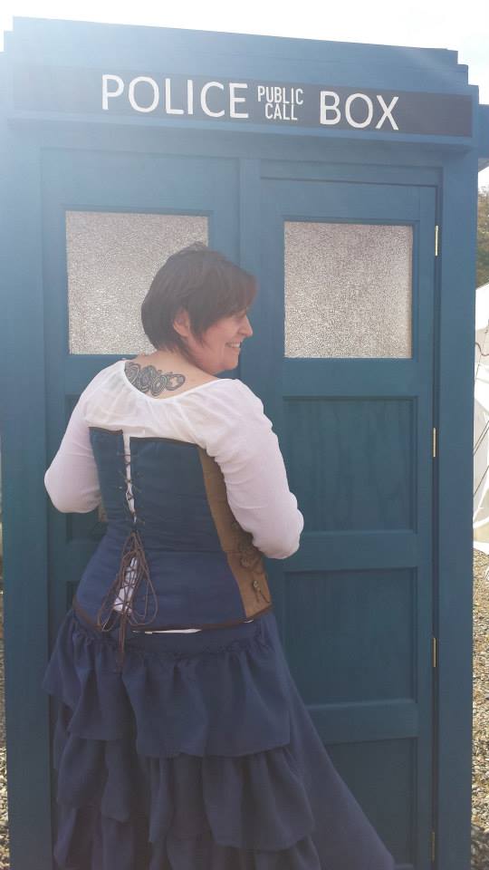 Person in doorway of Tardis from back